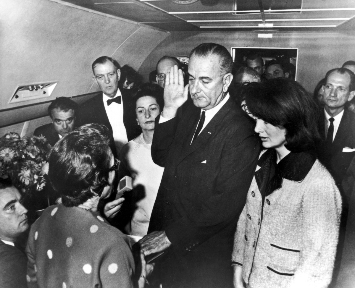 Vice President Lyndon Johnson taking oath of office after President Kennedy's assassination aboard Air Force One. 