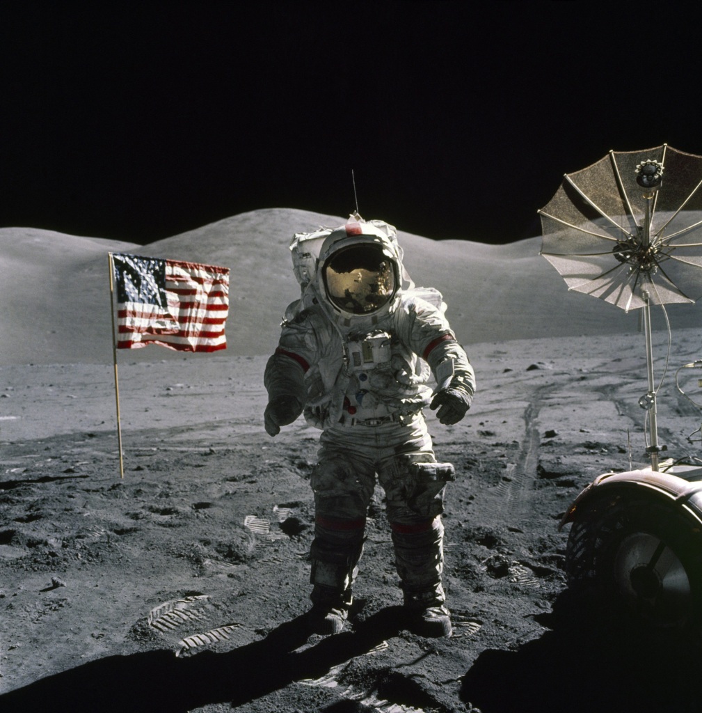 DECEMBER 12: Apollo 17 commander Eugene A. Cernan stands by the American flag during his second space walk becoming the last man to walk on the Moon on December 12, 1972. 