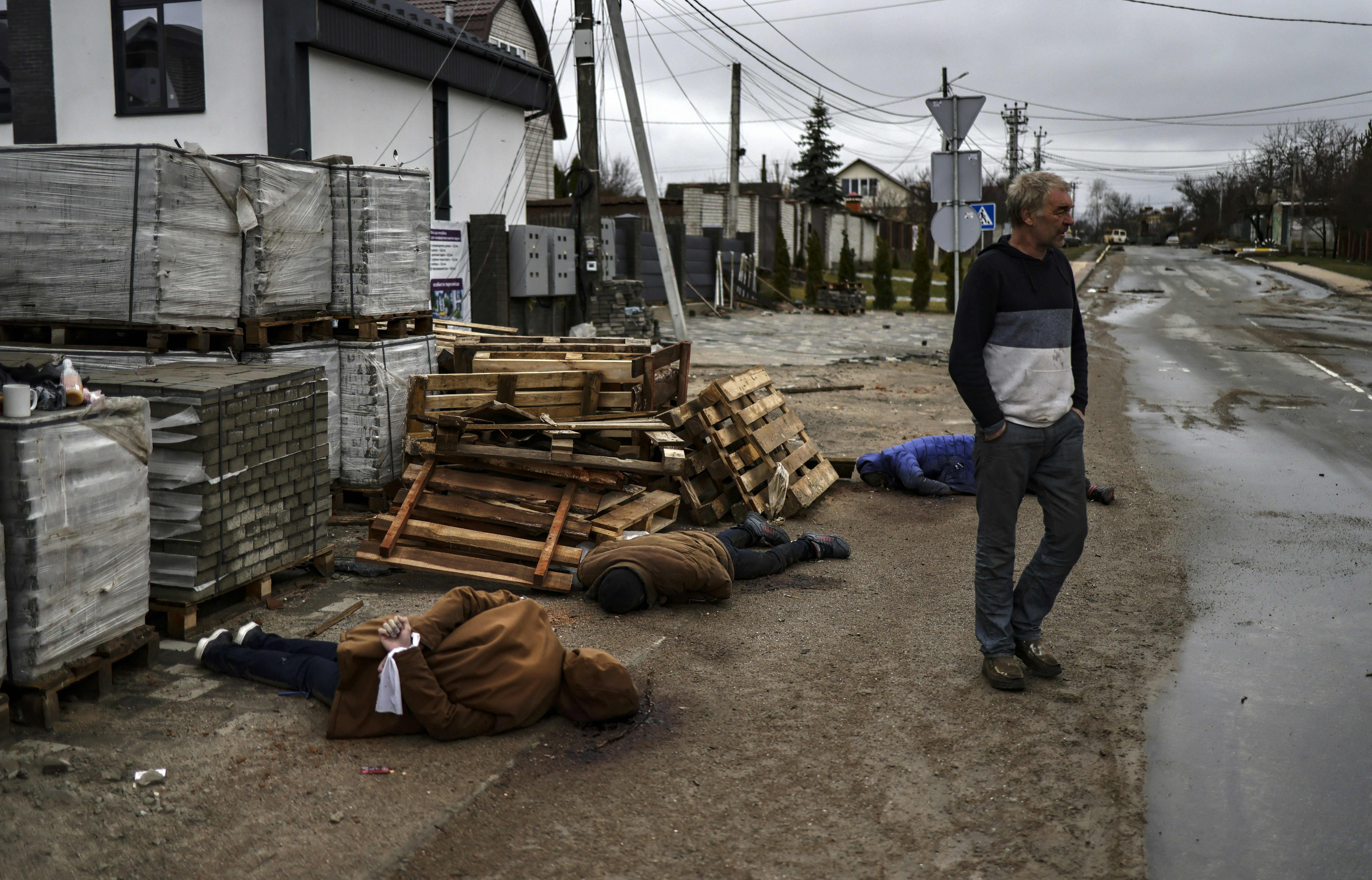 EDITORS NOTE: Graphic content / TOPSHOT - Dead bodies lie on a street in Bucha, northwest of Kyiv, on April 2, 2022, as Ukraine says Russian forces are making a &quot;rapid retreat&quot; from northern areas around Kyiv and the city of Chernigiv. - The bodies of at least 20 men in civilian clothes were found lying in a single street Saturday after Ukrainian forces retook the town of Bucha near Kyiv from Russian troops, AFP journalists said. Russian forces withdrew from several towns near Kyiv in recent days after Moscow's bid to encircle the capital failed, with Ukraine declaring that Bucha had been &quot;liberated&quot;. (Photo by RONALDO SCHEMIDT / AFP) (Photo by RONALDO SCHEMIDT/AFP via Getty Images)