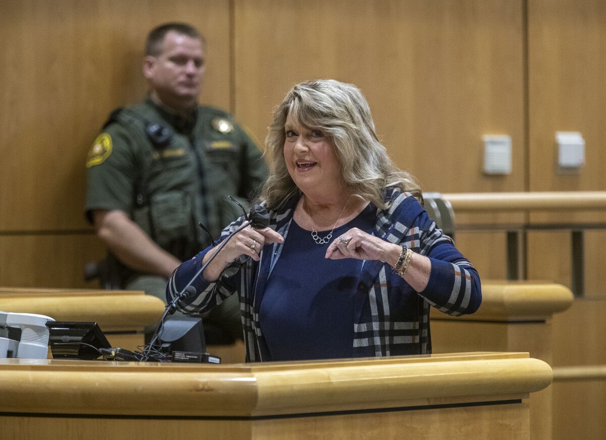 A woman speaks on a stand.