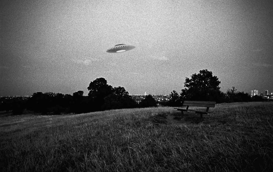 A digital composite of a UFO flying above an urban park.