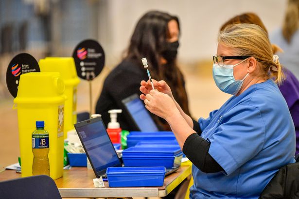 A healthcare worker preparing the Pfizer vaccine at a coronavirus vaccination centre