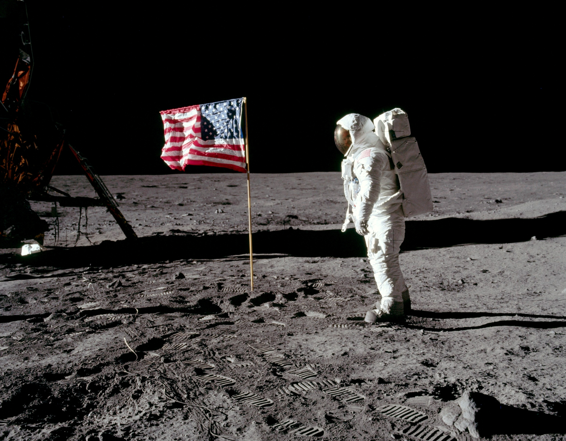 Some footage and photographs appear to show the American flag flapping during Moon missions