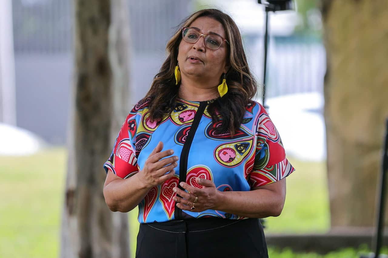 Mehreen Faruqi gazing towards the camera, uses her hands to communicate a point. 