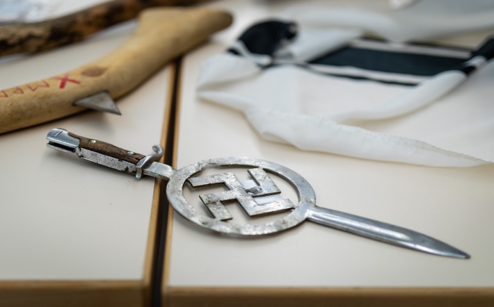 21 April 2022, Baden-Wuerttemberg, Heilbronn: A bayonet with an embedded swastika, which was seized during a police operation in Boxberg-Bobstadt, lies as evidence on a table at Heilbronn police headquarters. During an apartment search of a suspected Reichsbürger on suspicion of illegal weapons possession, there was an exchange of fire between the man and the police in Boxberg-Bobstadt - There was a police press conference today with details of the operation. Photo: Christoph Schmidt/dpa (Photo by Christoph Schmidt/picture alliance via Getty Images)