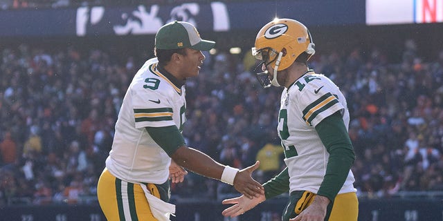 Green Bay Packers quarterbacks DeShone Kizer (9) and Aaron Rodgers (12) shake hands on the field during a game against the Chicago Bears Dec. 16, 2018, at Soldier Field in Chicago.