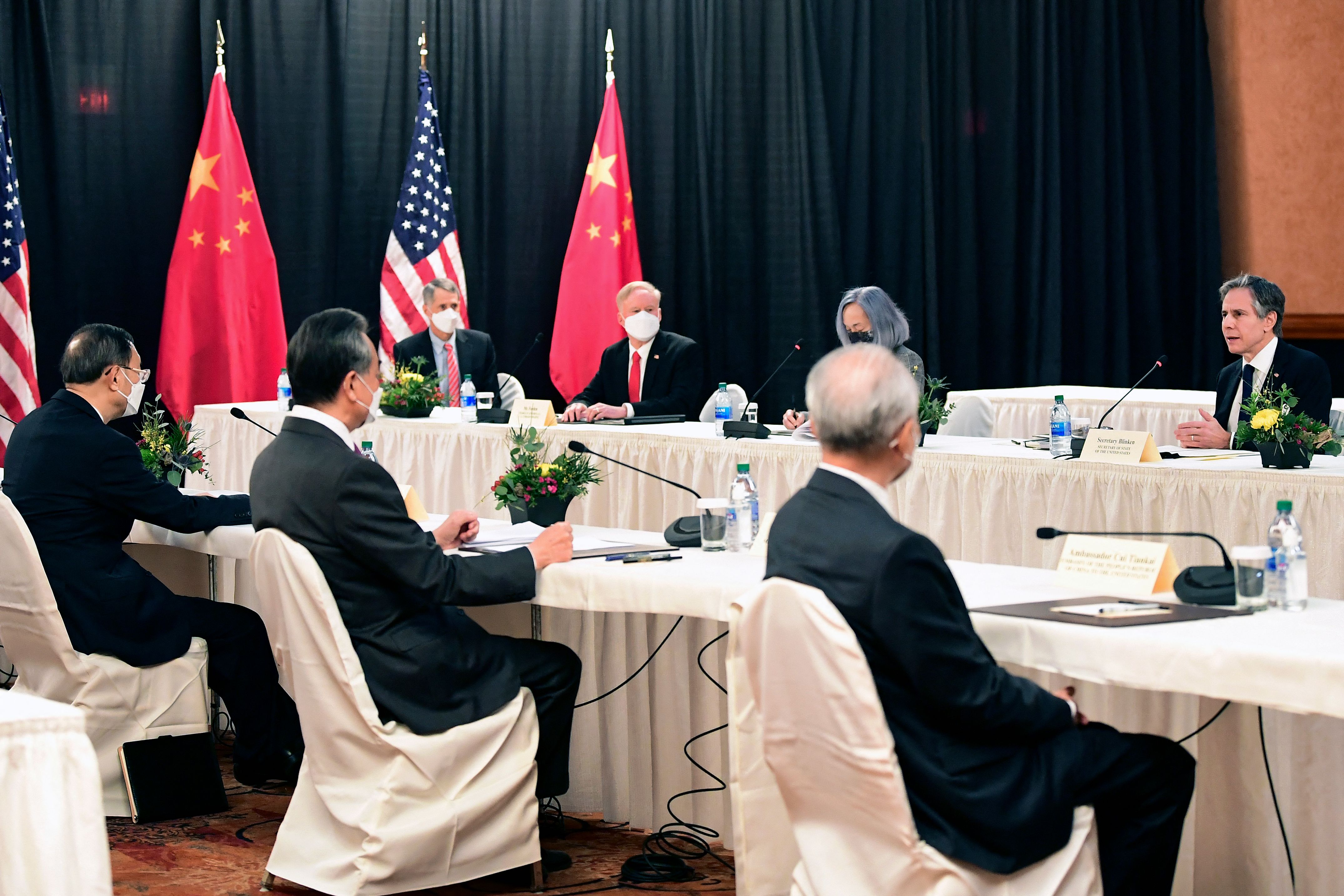 U.S. Secretary of State Antony Blinken (right) speaks while facing Yang Jiechi (left), director of the Central Foreign Affairs Commission Office, and Wang Yi (second from left), China's foreign minister, at the opening session of U.S.-China talks in Anchorage, Alaska, on March 18, 2021.