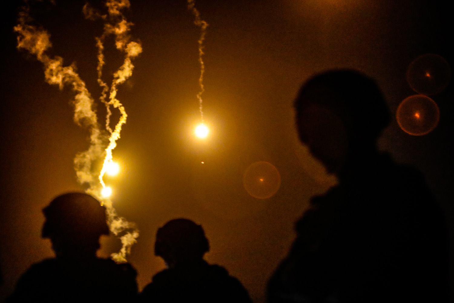 Taiwanese soldiers stand guard as flares are fired during a military drill after increasing China military activity near Taiwan.