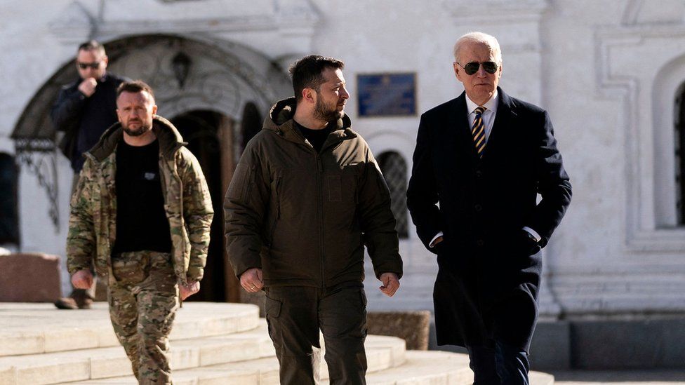 US President Joe Biden (r) walks with Ukrainian President Volodymyr Zelensky (C) at St. Michael's Golden-Domed Cathedral during an unannounced visit, in Kyiv on February 20, 2023