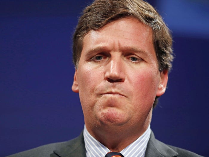 tucker carlson looking like he ate a lemon