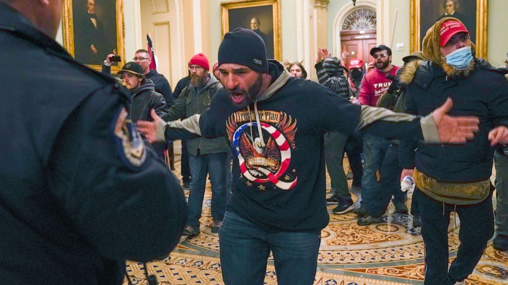 PHOTO: In this Jan. 6, 2021, file photo, Trump supporters, including Doug Jensen, center, confront U.S. Capitol Police in the hallway outside of the Senate chamber at the Capitol in Washington.