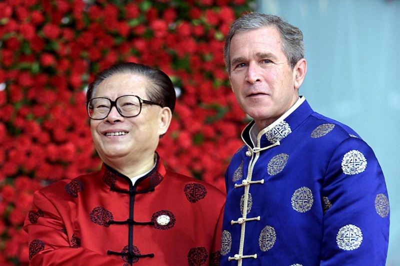 Chinese President Jiang Zemin greets U.S. President George W. Bush prior to a meeting of APEC leaders in 2001.