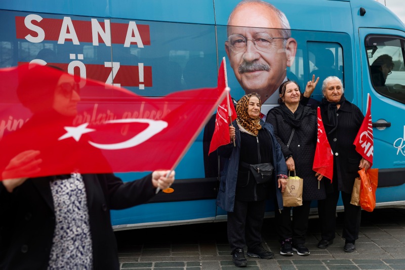 People wave flags near an election kiosk for Kemal Kilicdaroglu, presidential candidate and leader of the Republican People's Party (CHP), in Istanbul on May 11.