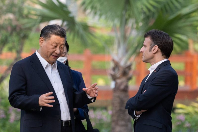 Chinese President Xi Jinping and French President Emmanuel Macron speak in the garden of the governor of Guangdong's residence in Guangzhou, China, on April 7.