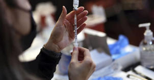 Roseland Community Hospital nurse Mariel Miagusko prepares doses of the Pfizer vaccine on Dec. 30, 2021, during a COVID-19 vaccination event at Josephine's Southern Cooking in Chatham.