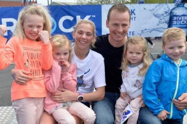 Laura Graham and husband Thomas with their family all sitting down and smiling