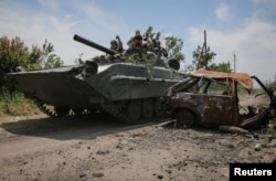 Ukrainian service members ride a BMP-1 infantry fighting vehicle near the front line in the newly liberated village of Neskuchne in the Donetsk region on June 13, 2023. (Oleksandr Ratushniak/Reuters)