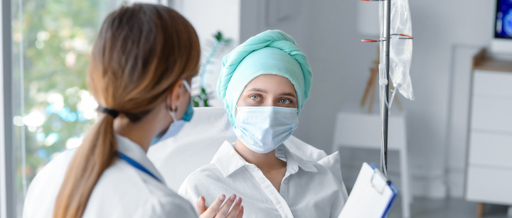 Doctor with woman undergoing chemotherapy