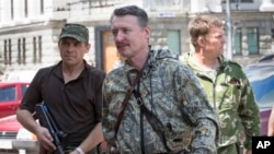 FILE - Igor Girkin, center, arrives for the wedding of platoon commander in Donetsk, Ukraine, July 11, 2014.