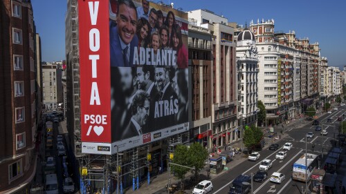 A giant electoral poster depicting Spain's Prime Minister and Socialist candidate Pedro Sánchez, top, and conservative PP party leader Alberto Nunez Feijóo and VOX far-right party leader Santiago Abascal is displayed on a building at the Gran Via avenue in Madrid, Spain, Monday, July 10, 2023. A general election on Sunday July 23, 2023, could make Spain the latest European Union member to swing to the right. Prime Minister Pedro Sánchez called the early election after his Spanish Socialist Workers' Party and its far-left partner, Unidas Podemos, took a beating in local and regional elections. (AP Photo/Manu Fernandez)