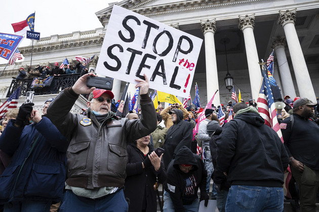 Supporters of former President Trump occupy the east front steps of the U.S. Capitol after breaching the security perimeter as they protest the certification of then-President-elect Biden's electoral-college victory Jan. 6, 2021. 