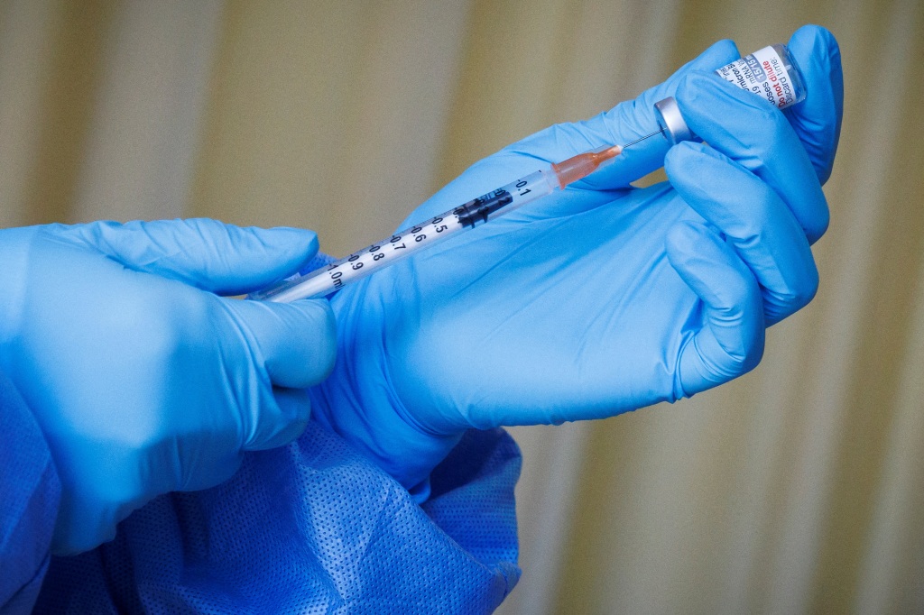 image of doctor preparing a COVID vaccine shot