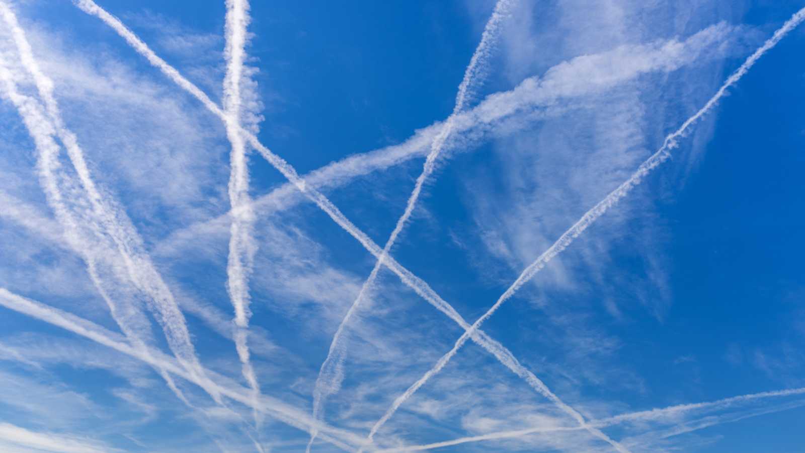 Contrails over blue sky.