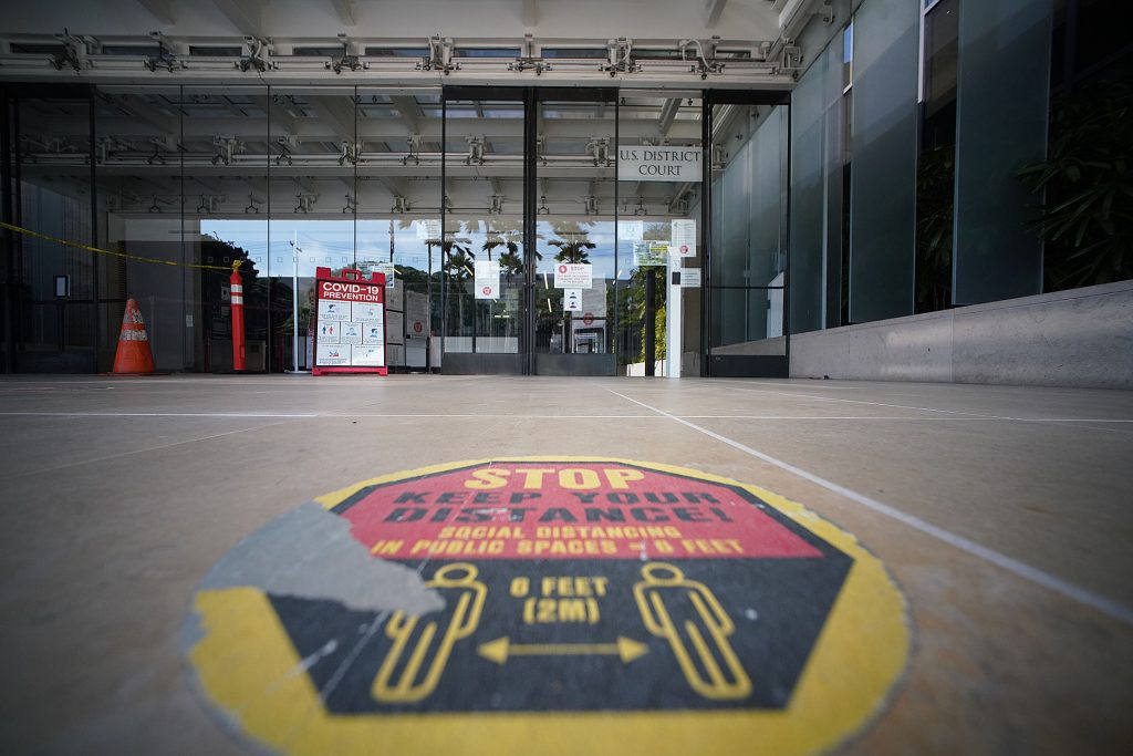 Federal Court entrance with an adhesive Covid-19 Social Distance decal on the ground reminding visitors. January 12, 2022.