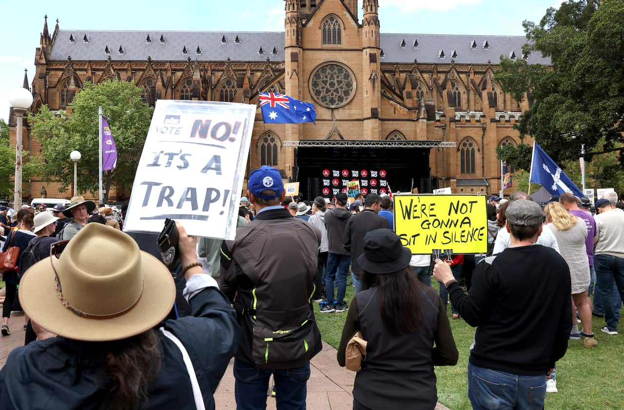 People hold placards in a rally. 