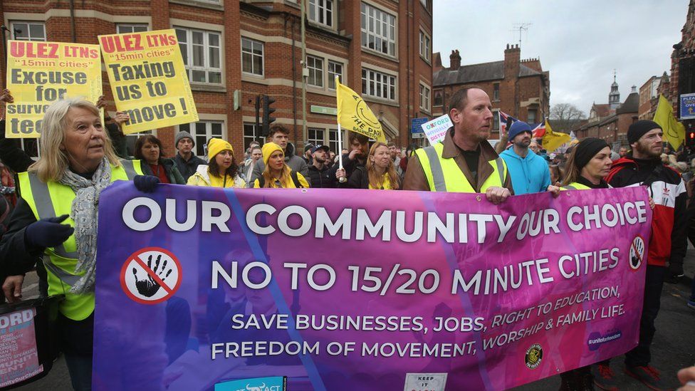 Protesters march across the city behind a large banner on February 18, 2023 in Oxford, England