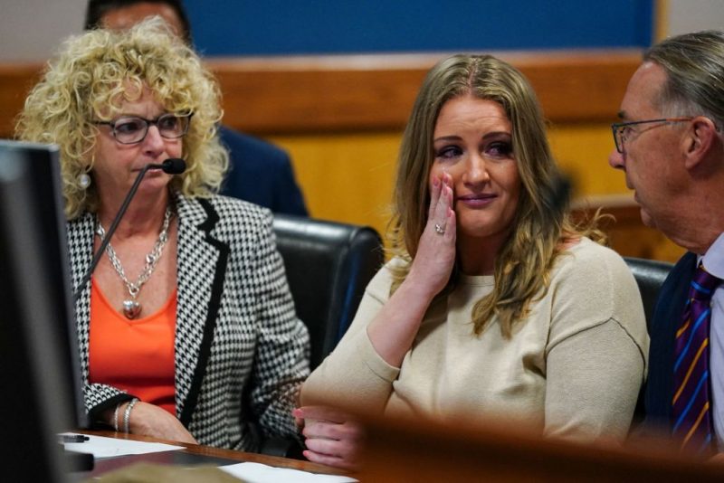 TOPSHOT - Jenna Ellis reacts with her lawyers after reading a statement pleading guilty to one felony count of aiding and abetting false statements and writings inside Fulton Superior Court Judge Scott McAfee's Fulton County Courtroom in Atlanta, Georgia, on October 24, 2023. Ellis, an attorney and prominent conservative media figure, reached a deal with prosecutors on Tuesday and pleaded guilty to a reduced charge over efforts to overturn Donald Trump's 2020 election loss in Georgia. (Photo by John Bazemore / POOL / AFP) (Photo by JOHN BAZEMORE/POOL/AFP via Getty Images)