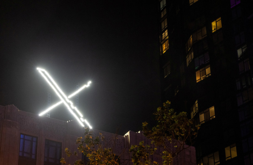  'X' logo is seen on the top of the headquarters of the messaging platform X, formerly known as Twitter, in downtown San Francisco, California, U.S., July 30, 2023. (credit: REUTERS/CARLOS BARRIA/FILE PHOTO)