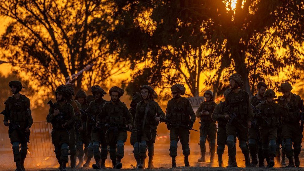 Israeli soldiers patrol the area of an attack that killed more than 260 people at a music festival