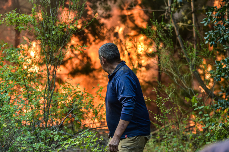 A volunteer helps fight a forest fire in El Patagual, Chile