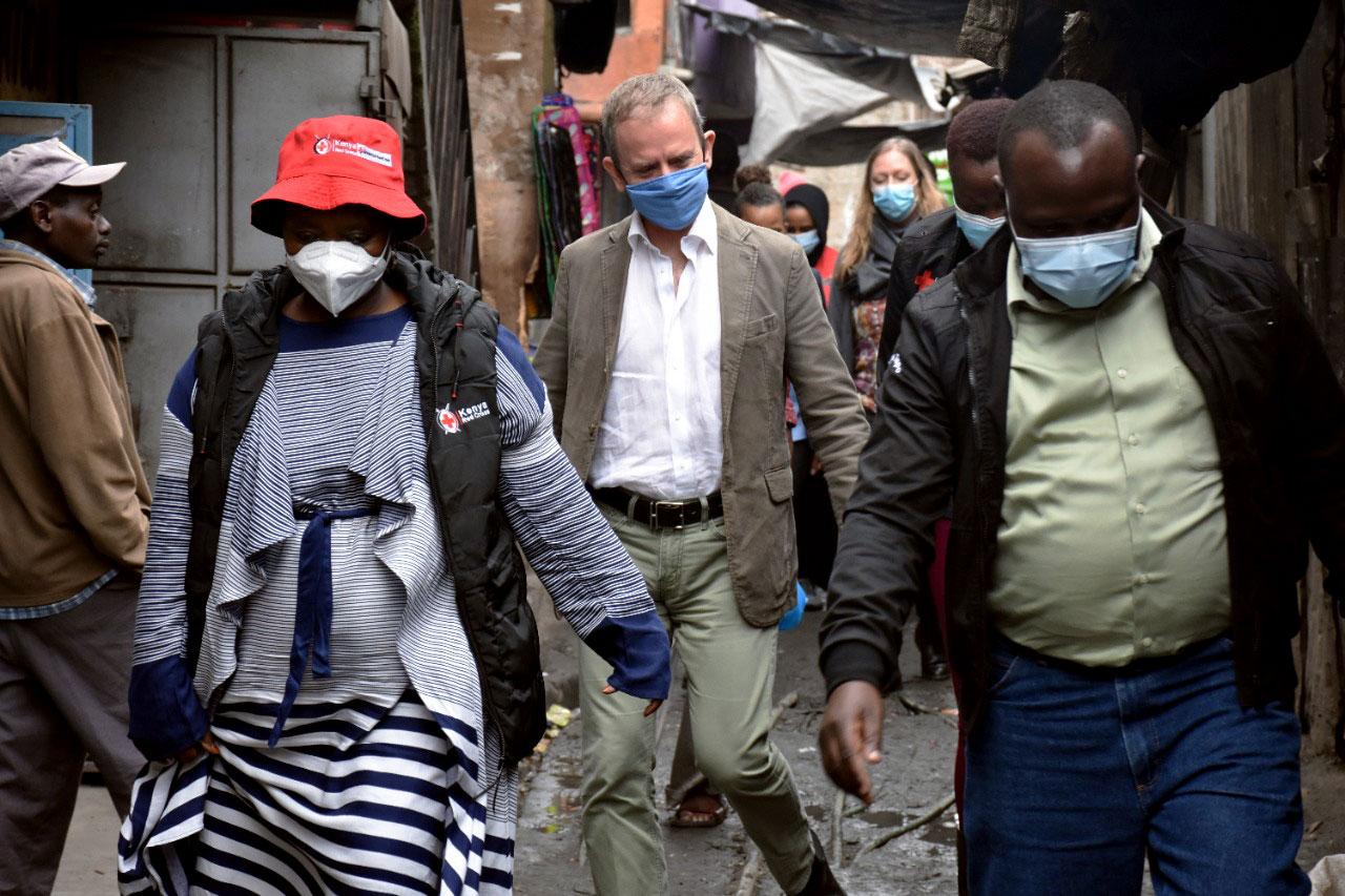 Stephen walking through slums accompanied by others.