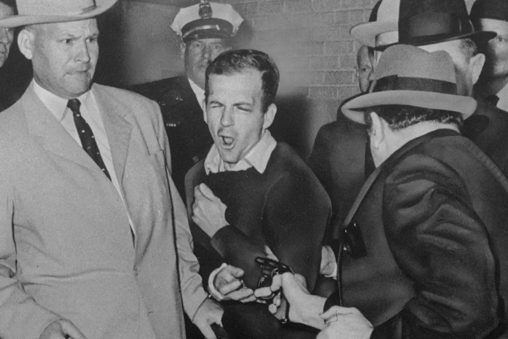 Lee Harvey Oswald is shot by Jack Ruby in a corridor of Dallas police headquarters