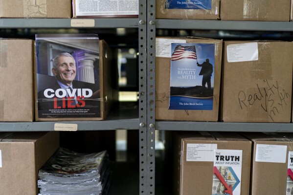 Boxes of John Birch Society literature waiting to be distributed pamphlets and reports on a range of issues from COVID to inflation are stored in a warehouse at the headquarters of the John Birch Society in Appleton, Wis., Thursday, Nov. 17, 2022. (AP Photo/David Goldman)