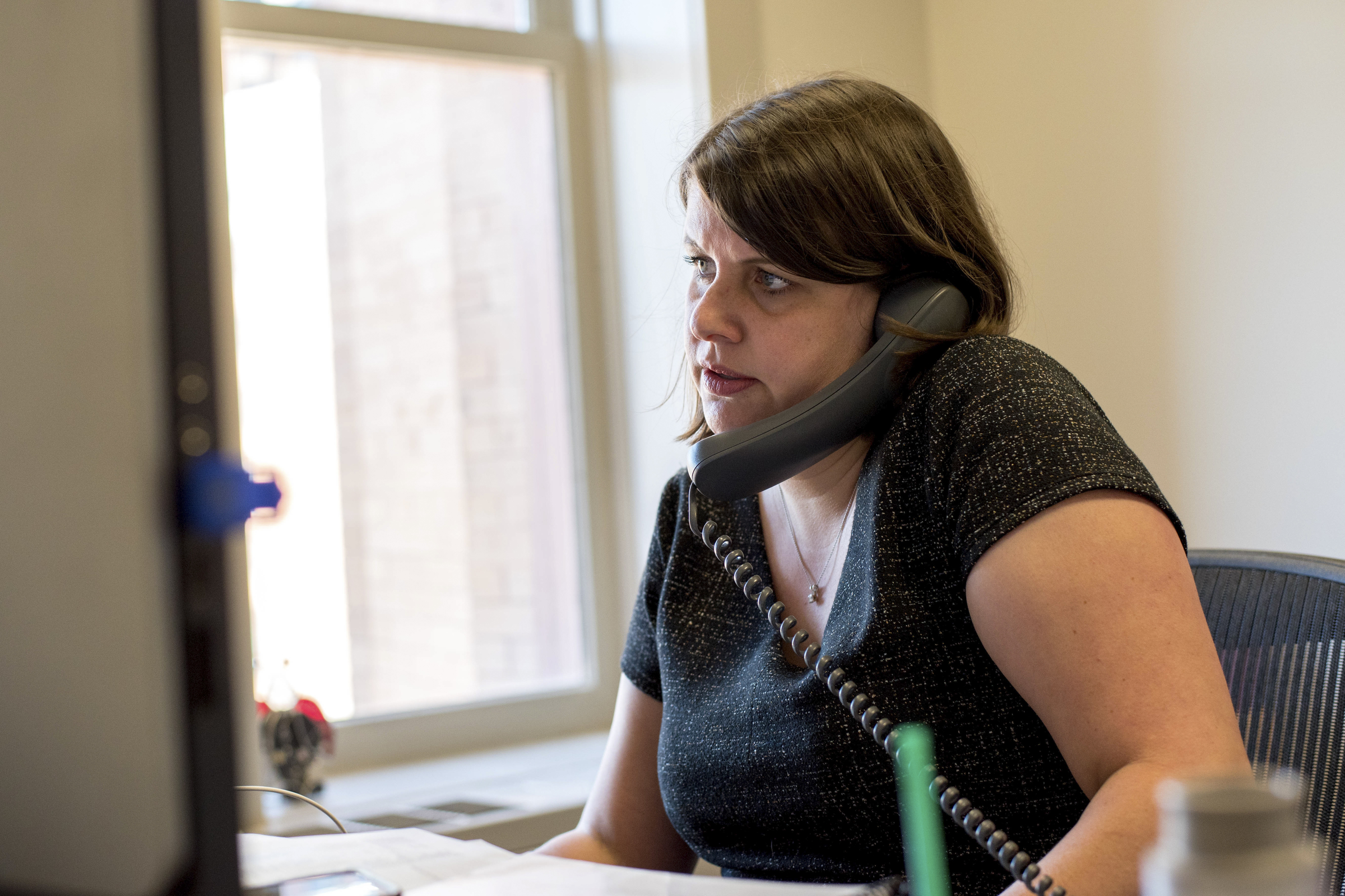 Claire Woodall-Vogg speaks on the phone from her office at City Hall