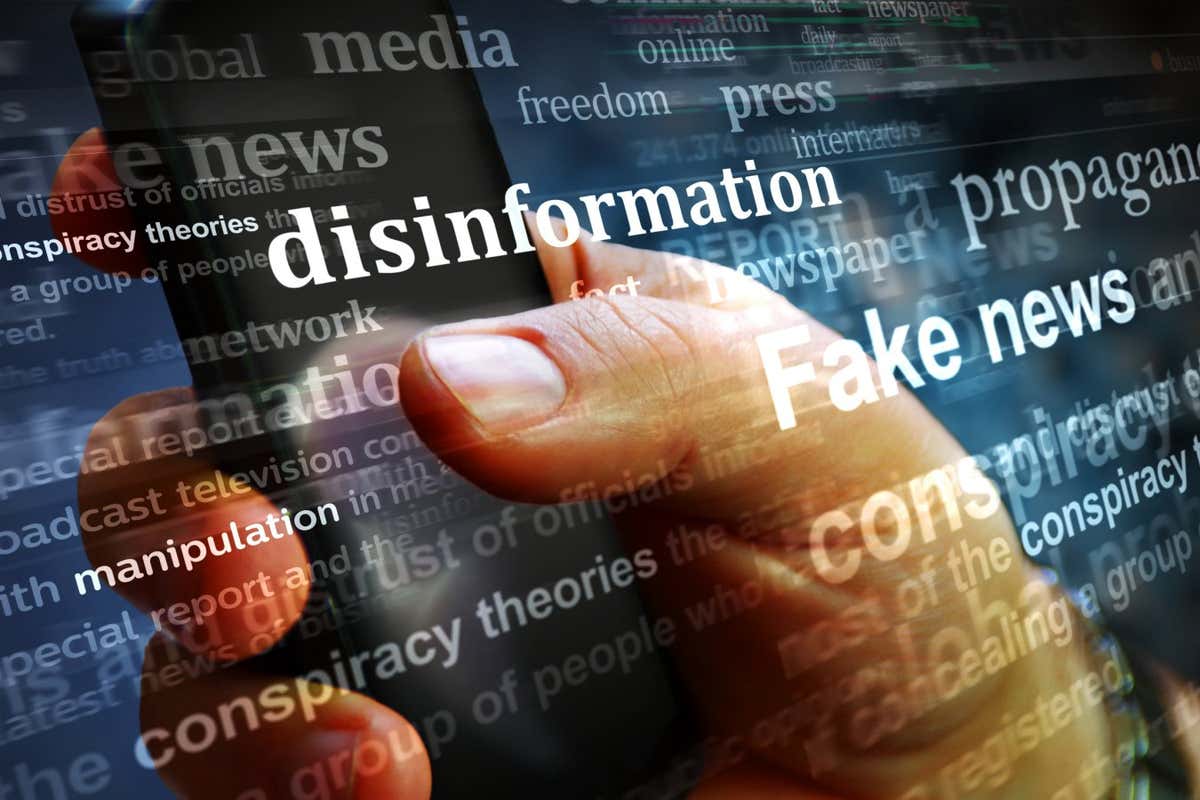 Illustration of a computer screen showing words including disinformation and fake