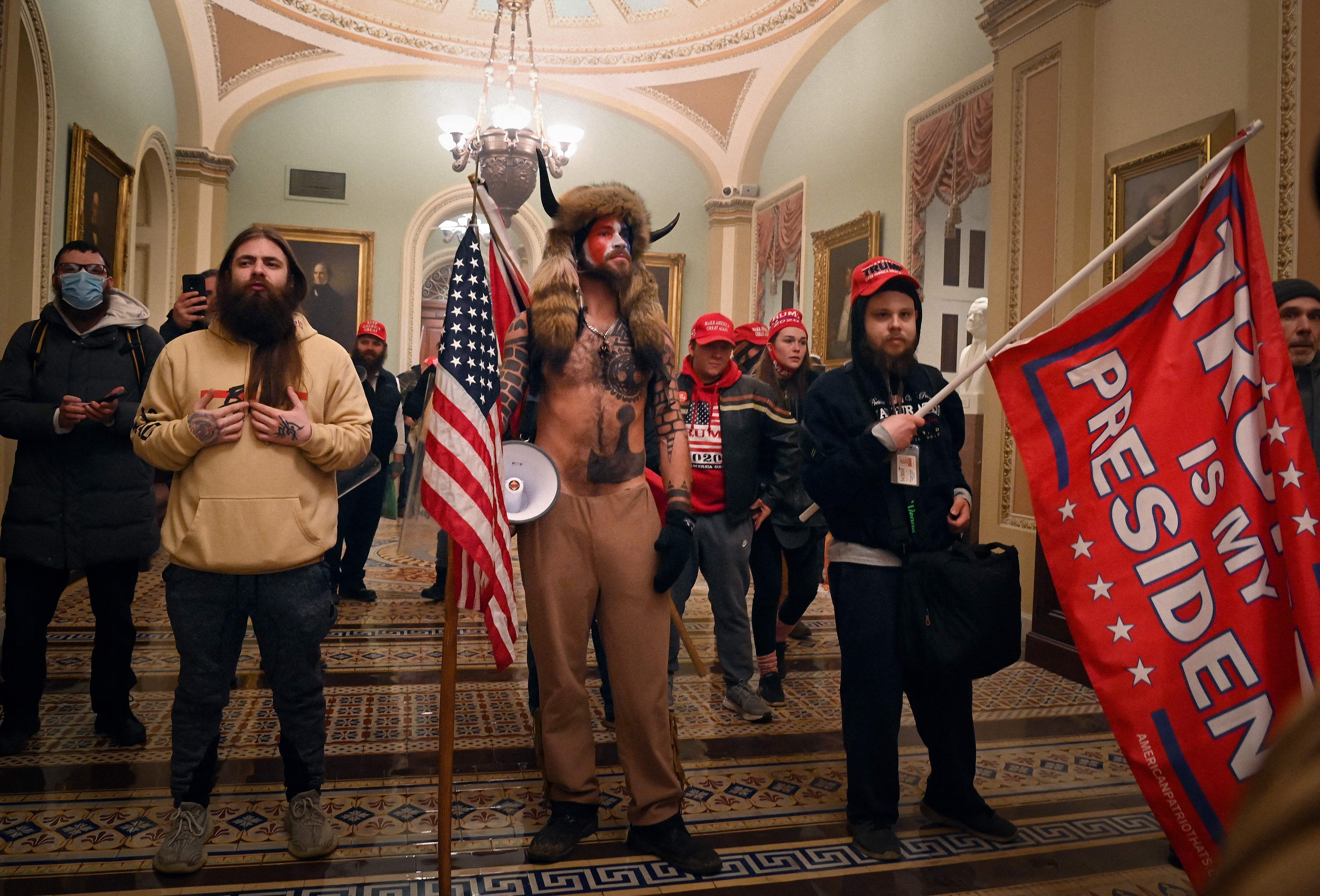 Supporters of QAnon storming the capitol