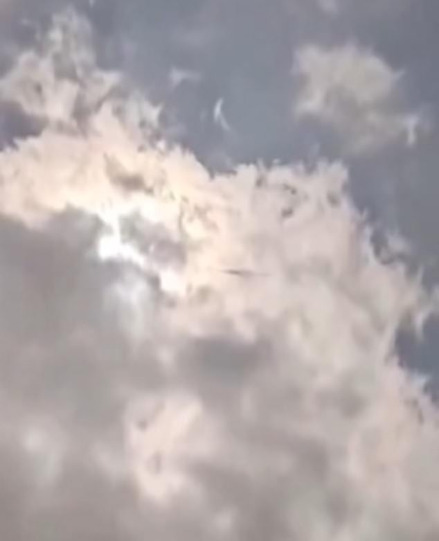 The footage shows glowing clouds hanging in a darkened sky when the object appeared to be swimming b