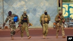 FILE - This undated photo from the French military shows three Russian mercenaries, right, in Mali. (French Army via AP, File)