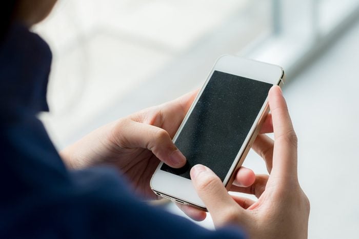 Close up of business woman handing smartphone.