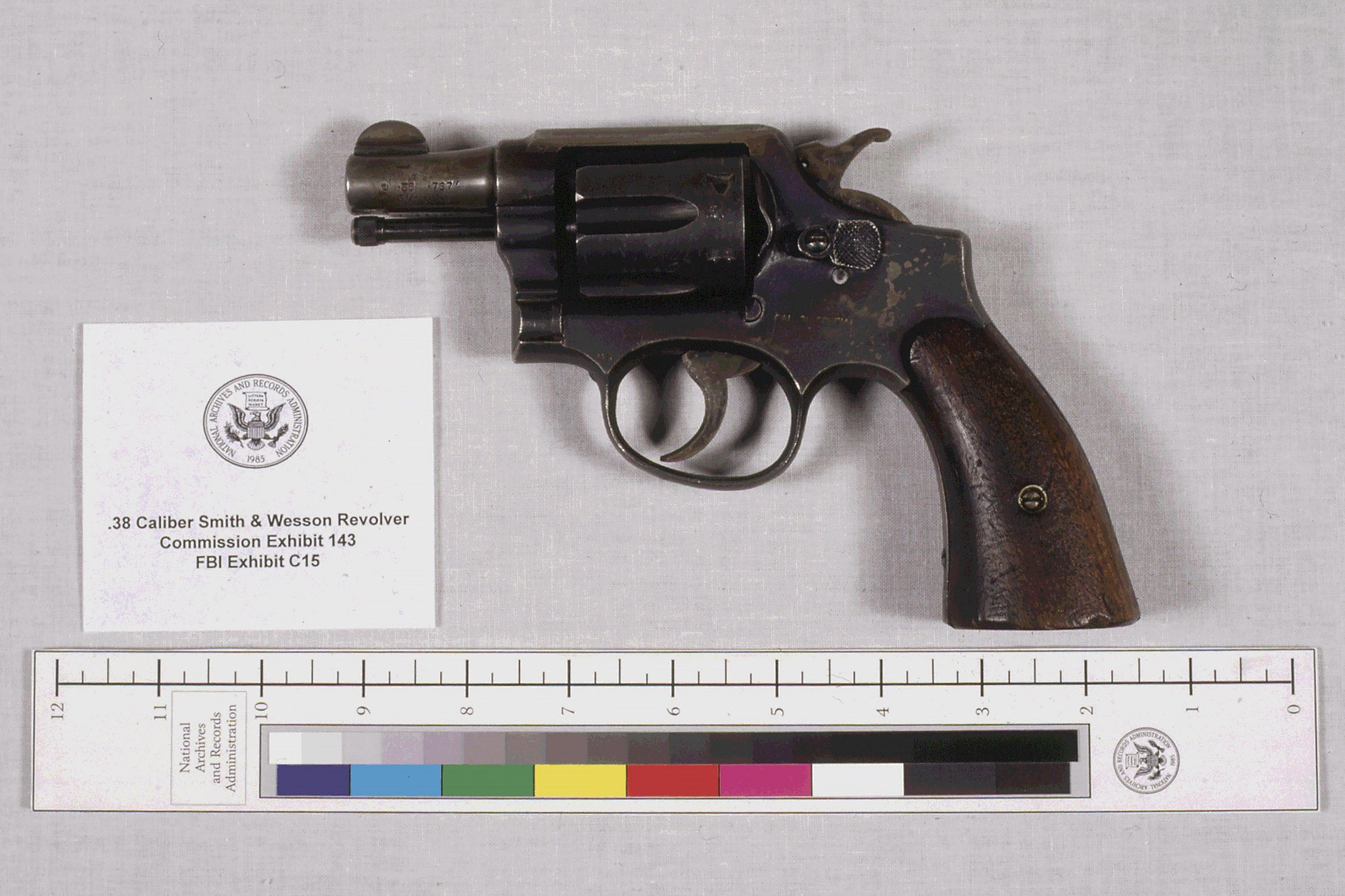 A small handgun is displayed next to a card describing it as FBI Exhibit C15.