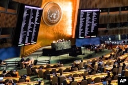 Video monitors show U.N. member nation vote in the United Nations General Assembly in favor of a resolution condemning Russia's illegal referendum in Ukraine, on October 12, 2022 at the U.N. headquarters. (Bebeto Matthews/AP)