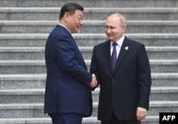 Russia's President Vladimir Putin and China's President Xi Jinping attend an official welcoming ceremony in front of the Great Hall of the People in Tiananmen Square in Beijing on May 16, 2024. (Sergei Bobylyov/Sputnik)