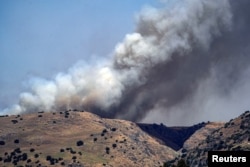 Smoke rises amid ongoing cross-border hostilities between Hezbollah and Israeli forces, in the Israeli-occupied Golan Heights, on June 13, 2024. (Ayal Margolin/Reuters)