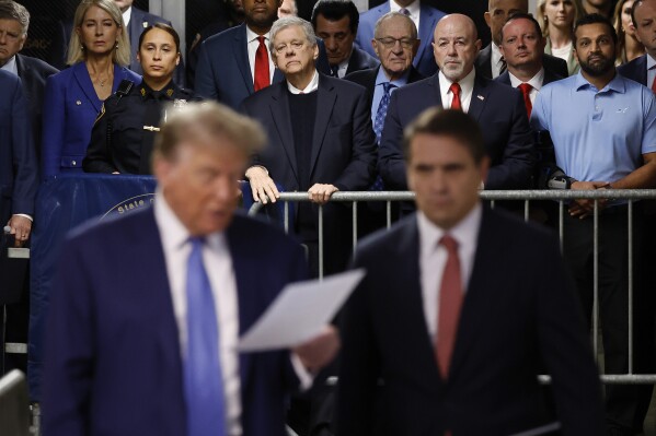 FILE - With Kash Patel at background right, former President Donald Trump speaks to members of the media with his attorney Todd Blanche at Manhattan Criminal Court on Monday, May 20, 2024 in New York. (Michael M. Santiago/Pool Photo via AP, File)