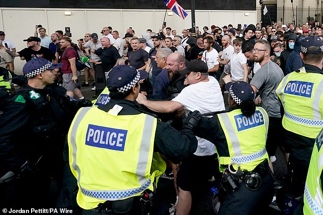 A group of protesters, many with Union Jack and England flags, clash with police outside Downing Street on Wednesday