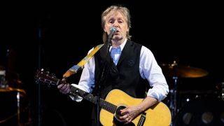 Paul McCartney sings and plays the guitar